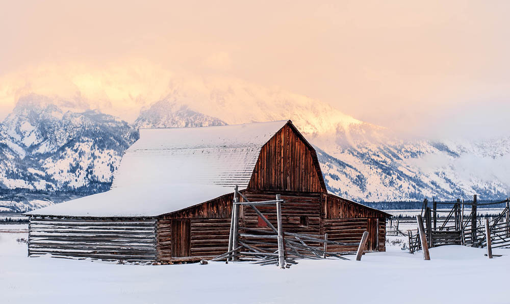grand tetons in the winter snow covered barn