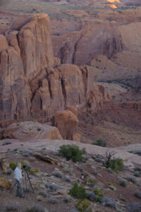 A photographer in the desert landscape of Canyon de Chelley