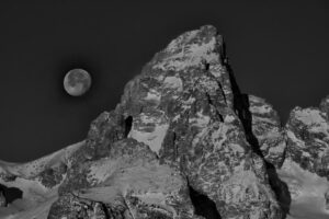 Teton mountains with a full moon in monochrome